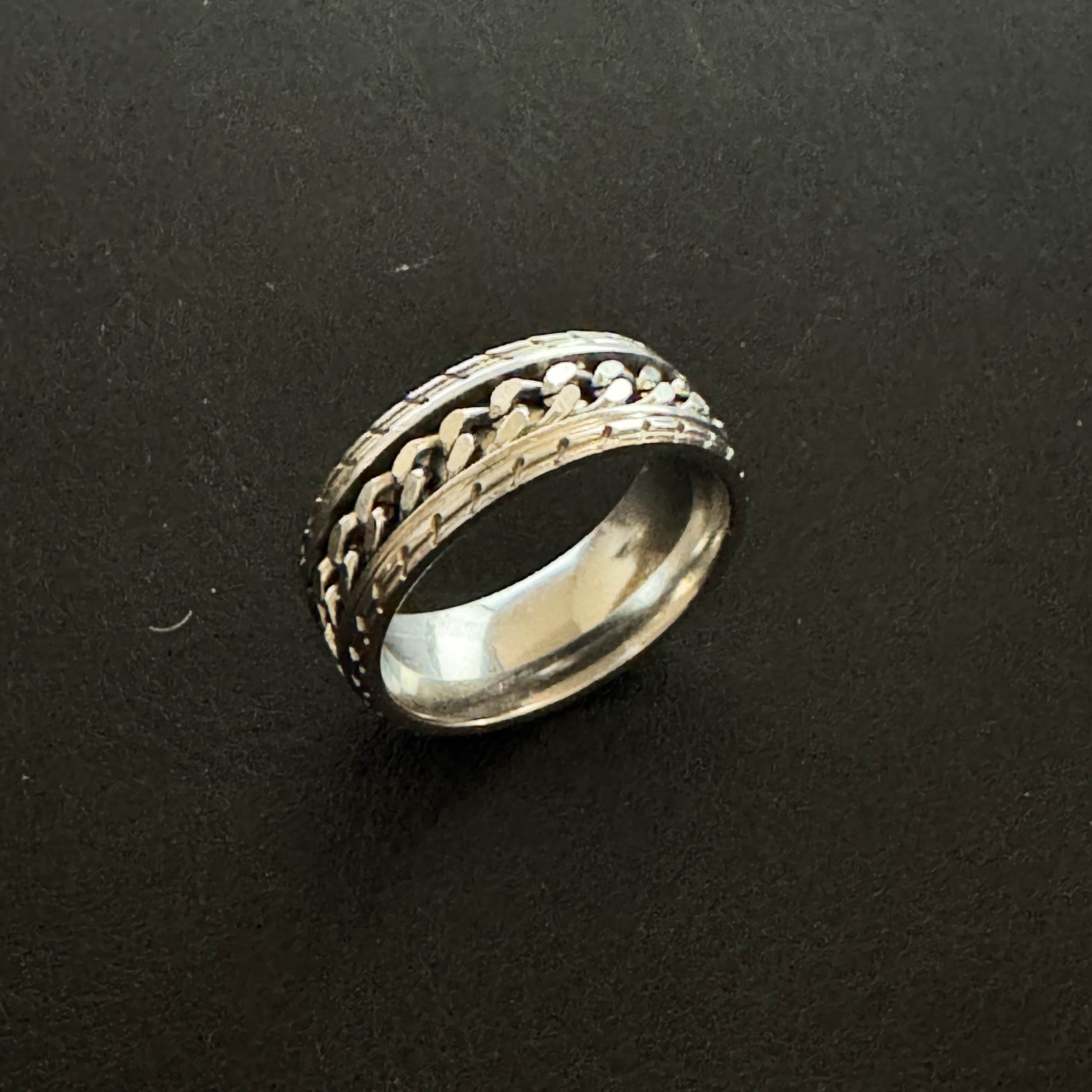 This is one of the thirteen rings I wear. It's a fidget ring gifted to me by my boyfriend. This is the sound it makes when I spin the middle chain.